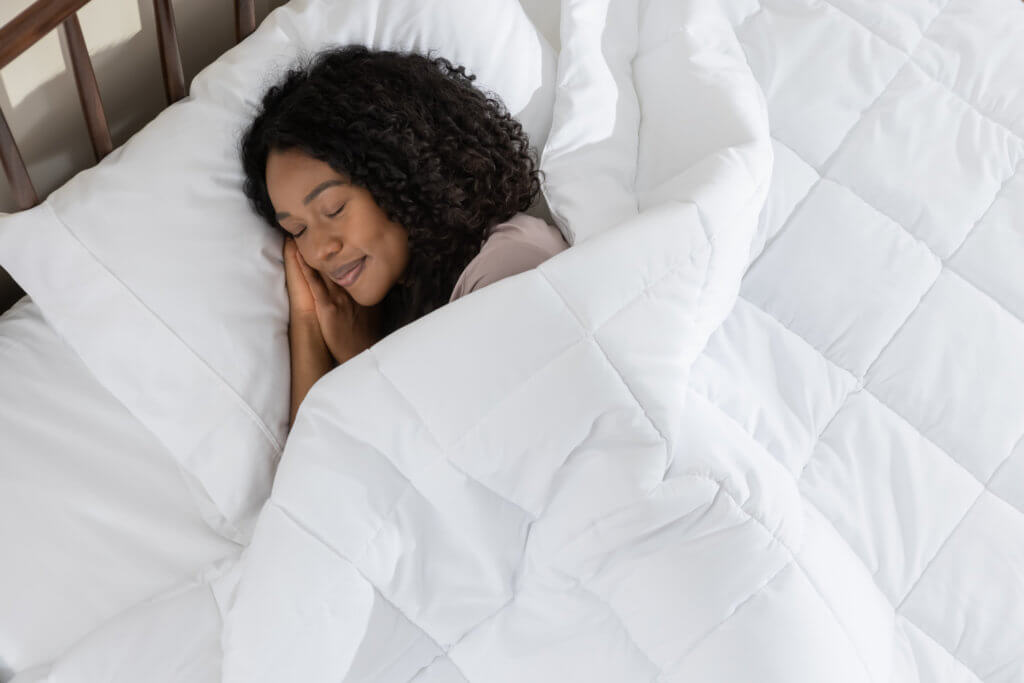Woman snuggling with her down alternative duvet