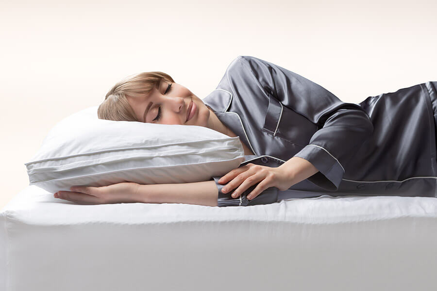 Woman sleeping peacefully on Logan & Cove hybrid mattress