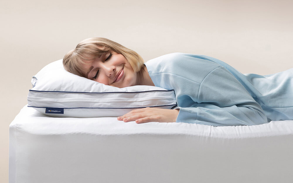 memory-foam-pillow-stomach-1000x625 Woman in light blue pajamas peacefully sleeping on her side, head resting on the Adjustable Memory Foam Pillow