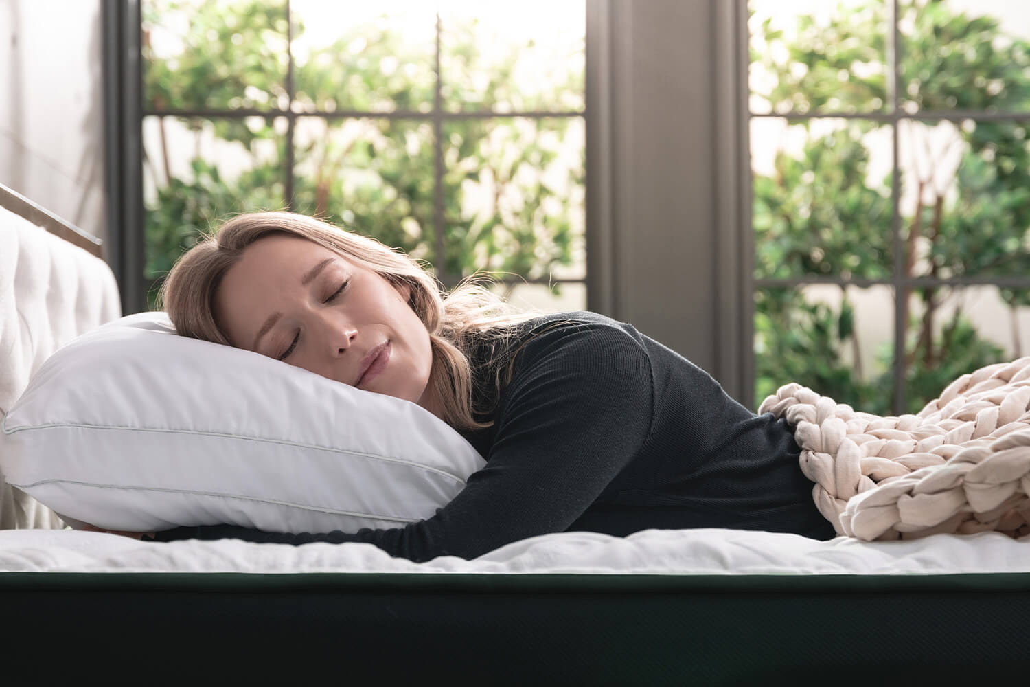 Woman sleeping on her stomach on a Logan &amp; Cove Adjustable Memory Foam Pillow