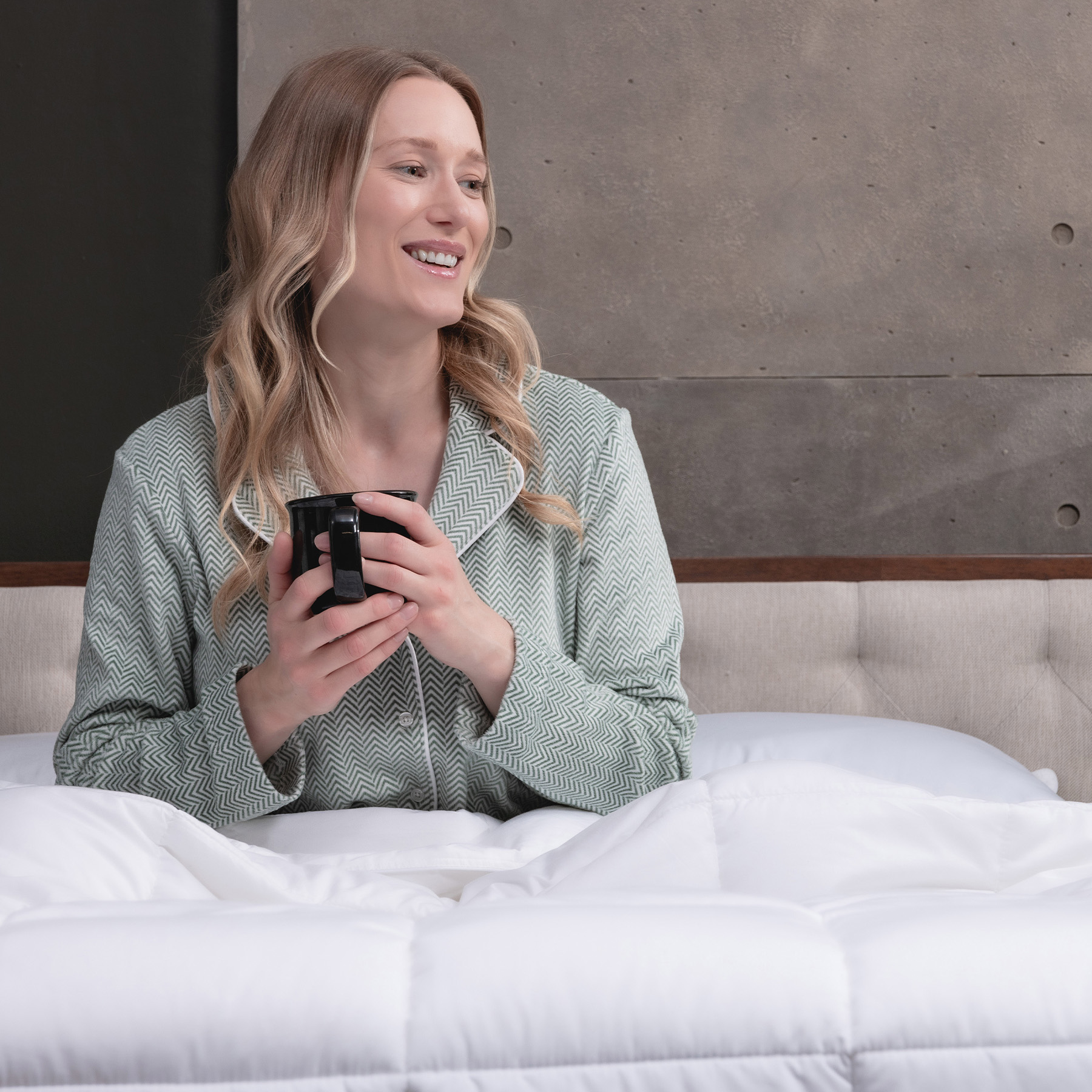 LC-Down-Alternative-Duvet-Carousel-5 Woman smiling in bed with her Logan & Cove Down Alternative Duvet