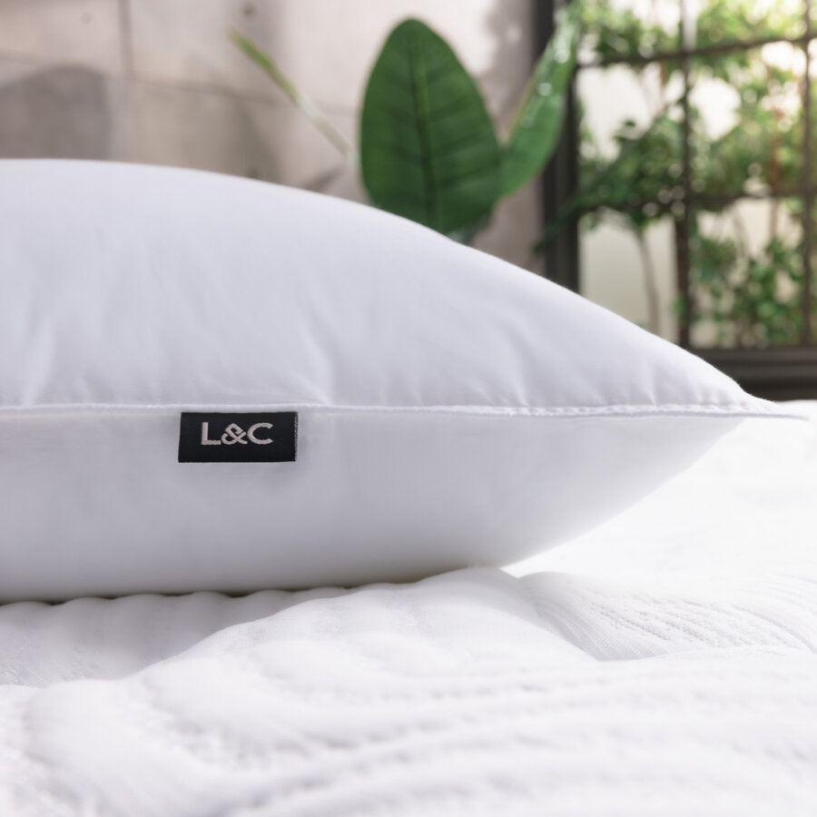 Side view of Logan & Cove Down Alternative Pillow with brand tag