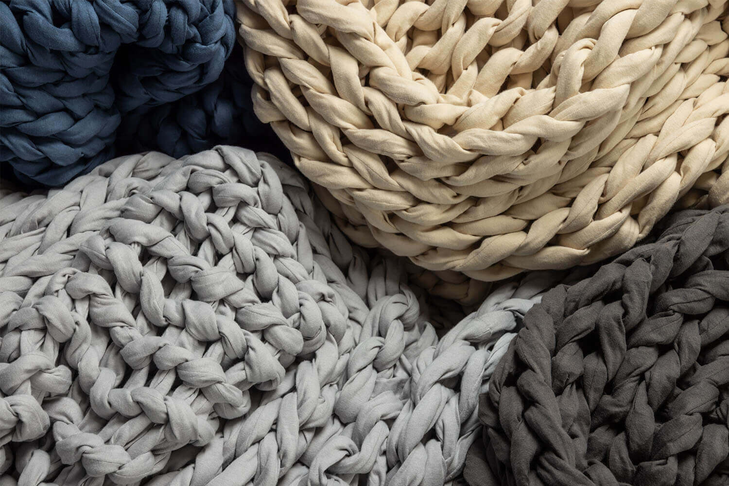 Close up of the four available Douglas Hand Knit Weighted Blanket colours: Dark Grey, Light Grey, Navy, and Cream